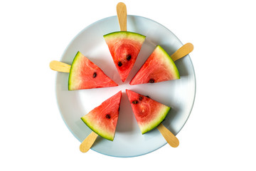 watermelon cut slice on a stick from ice cream close-up on white plate isolated