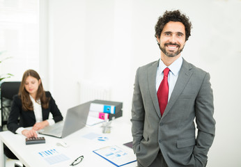 Smiling businessman in his office