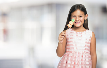 Smiling little child holding a candy