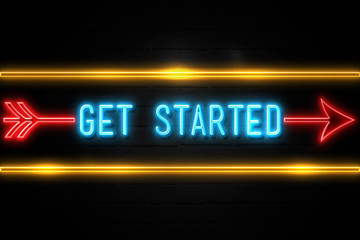 Get Started  - fluorescent Neon Sign on brickwall Front view