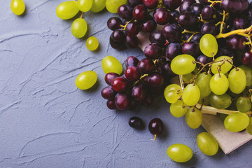 Fresh grapes on gray stone background. Copyspace.