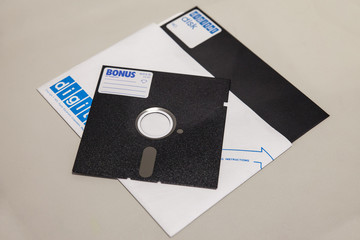 Old 5.25 and 8 inch floppy disks isolated on light background