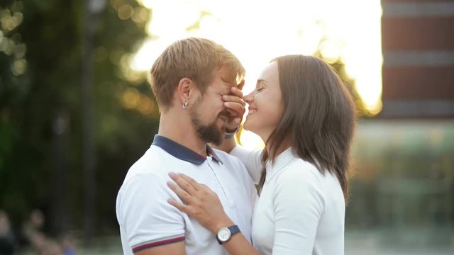 Outdoors Portrait of Young Couple in Love Kissing and Hugging During Sunset in the City.