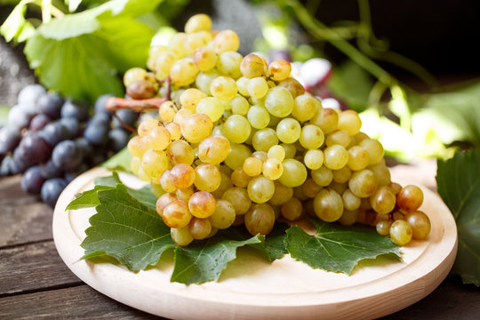 white grapes on a wooden background.
