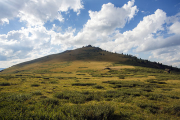 mountain in the form of a triangle. Blue sky.