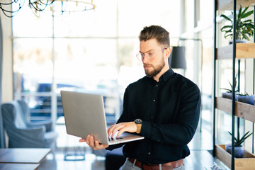 Young business man executive using laptop in office