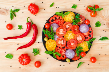 Fresh chopped tomatoes on a plate on a wooden table