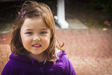 Young girl with timid smile