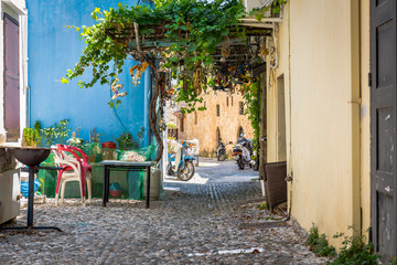 Naklejka na ściany i meble Narrow street with beautiful yard on Rhodes island, Greece 