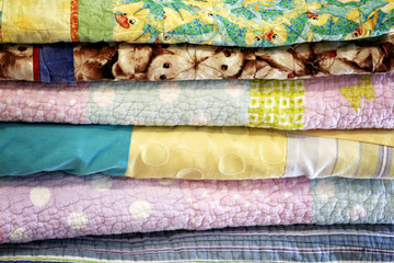 Stock of colorful old washed blankets folded after laundry.