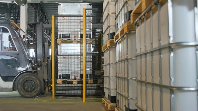 Side View Modern Powerful Forklift Takes and Transports Tanks