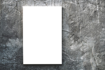White sheet of paper or blank billboard for advertising hanging on modern concrete wall or texture on modern city. Concept