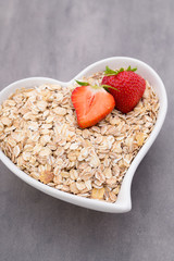 Dry rolled oatmeal in bowl.