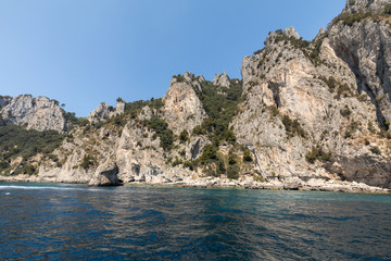 Fototapeta na wymiar View from the boat on the cliff coast of Capri Island, Italy