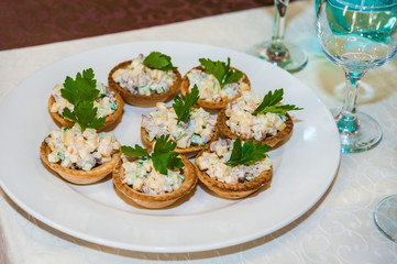 Russian salad boiled vegetables with meat and mayonnaise tartlets
