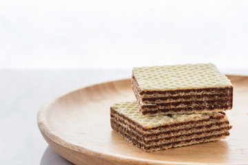 Closeup image, wafers on a wooden plate.