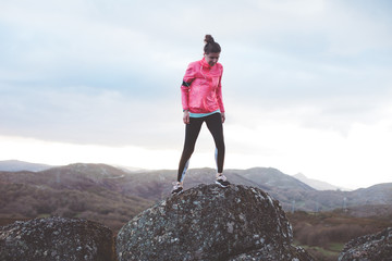 Obraz premium Athlete girl trains in the mountains. Sport tight clothes. Intentional motion blur.