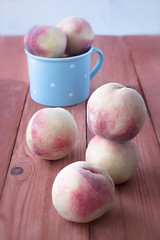 Fresh peaches on a wooden table