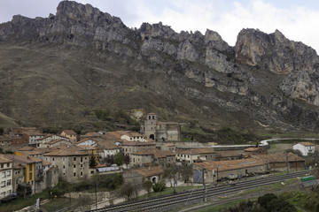 Fototapeta na wymiar A view of village Pancorbo in the mountains with a railway going through, Spain