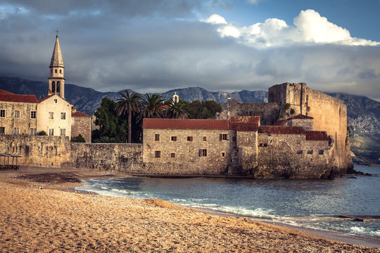 Old European landmark sea fort with medieval architecture at sunset beach in Europe country Montenegro of Balkans peninsula