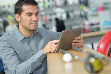 man with digital tablet in hardware store