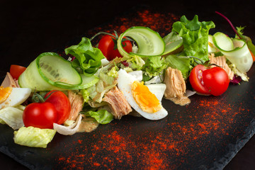 Salad of chicken eggs and tomato.
