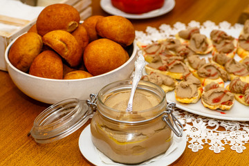 The chicken liver pate in a glass jar is on the table.