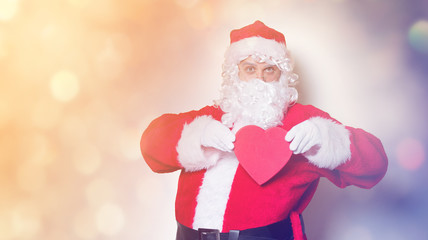 Santa Claus holding heart shape gift