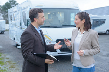 male renting agent talking with female client hiring an rv