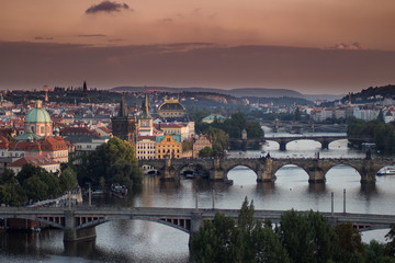 Fototapeta na wymiar View of the Prague bridges with orange sky from above