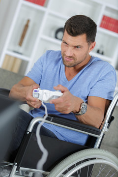 man in wheelchair plays video-games