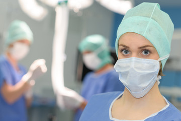 female surgeon surrounded by her team