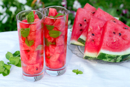 Detox water with watermelon and mint. Slices of watermelon with mint leaves. Watermelon drink in glasses with slices of watermelon.