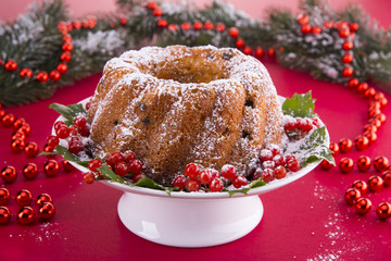 Fototapeta na wymiar Christmas pudding with a viburnum on a festive table