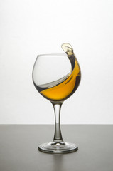 splashing wineglass with juice