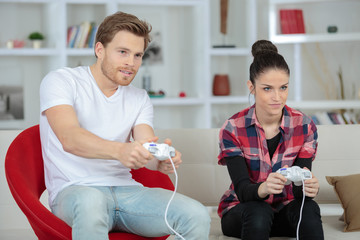 young couple playing video games in their apartment