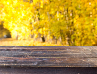 Naklejka na ściany i meble empty wooden table with autumn nature background