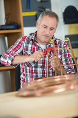 craftman cutting a cooper cable