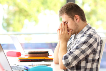 Tired student alone in a classroom