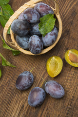 garden plums on a wooden table close up