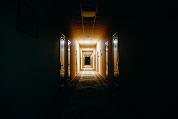 Dark corridor with many doors