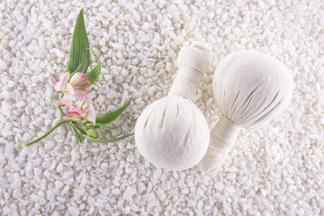 Spa. Still life. Herbal balls  and Altromeria  on a background of white pebbles.