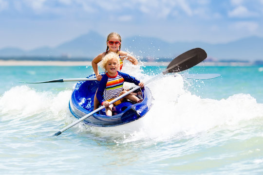 Kids Kayaking In Ocean. Children In Kayak In Tropical Sea