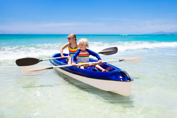 Kids kayaking in ocean. Children in kayak in tropical sea