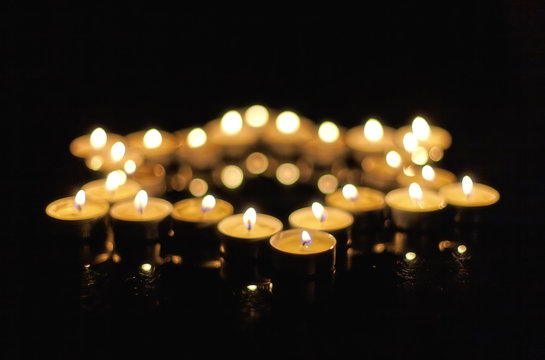 Burning Candles In The Shape Of A Star Of David On A Black Background. Bokeh On Dark Backdrop, Shallow Depth Of Field