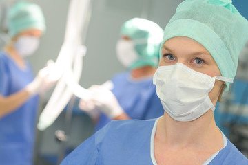 surgeon wearing protective mask and cup ready for operation