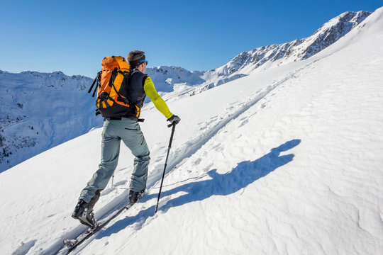 Male ski tourer hiking in the alps