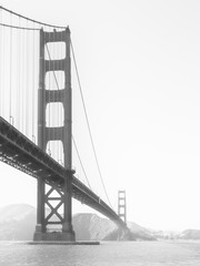 Golden Gate Bridge in the morning fog, San Francisco, California, USA. Black and white image.