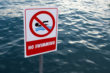 warning sign, "No Swimming". Turkish quay in the city of Marmaris
