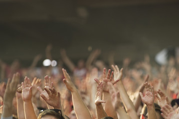 Football fans clapping on the podium of the stadium